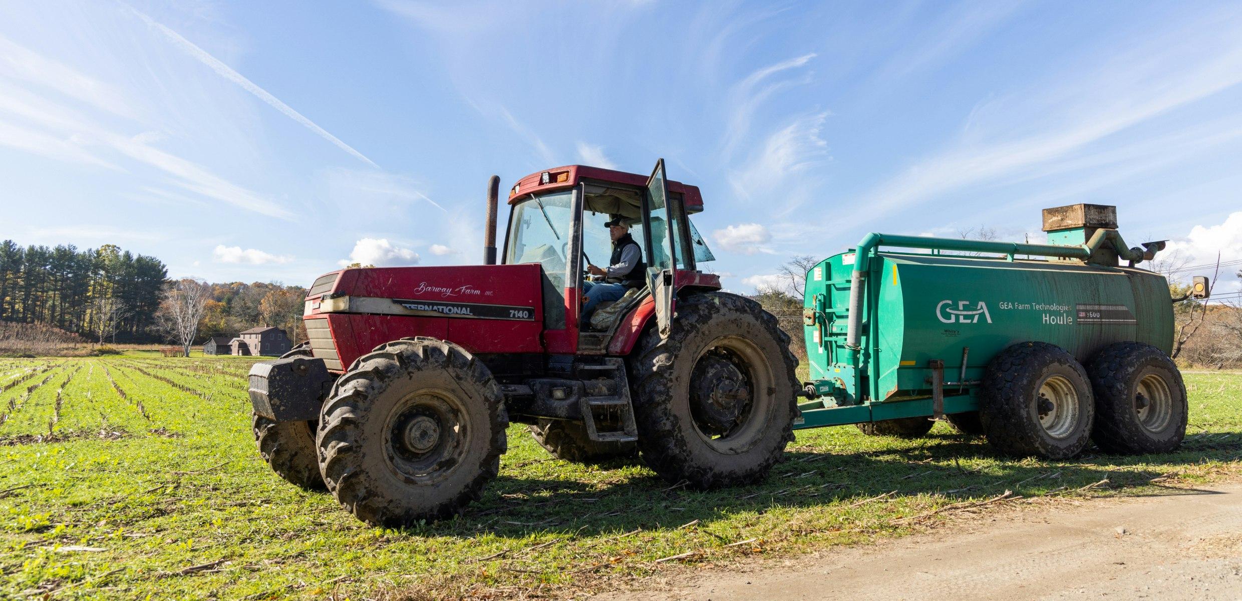 Tractor distributing low-carbon sustainable fertilizer from anaerobic digestion