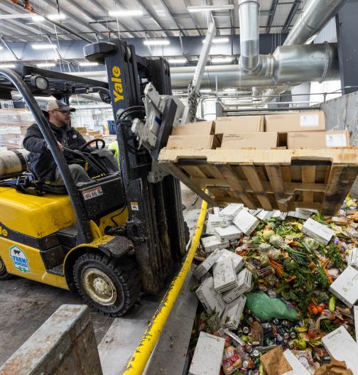 Depackaging waste at a organic waste recycling facility, preparing the food waste for farm powered anaerobic digestion